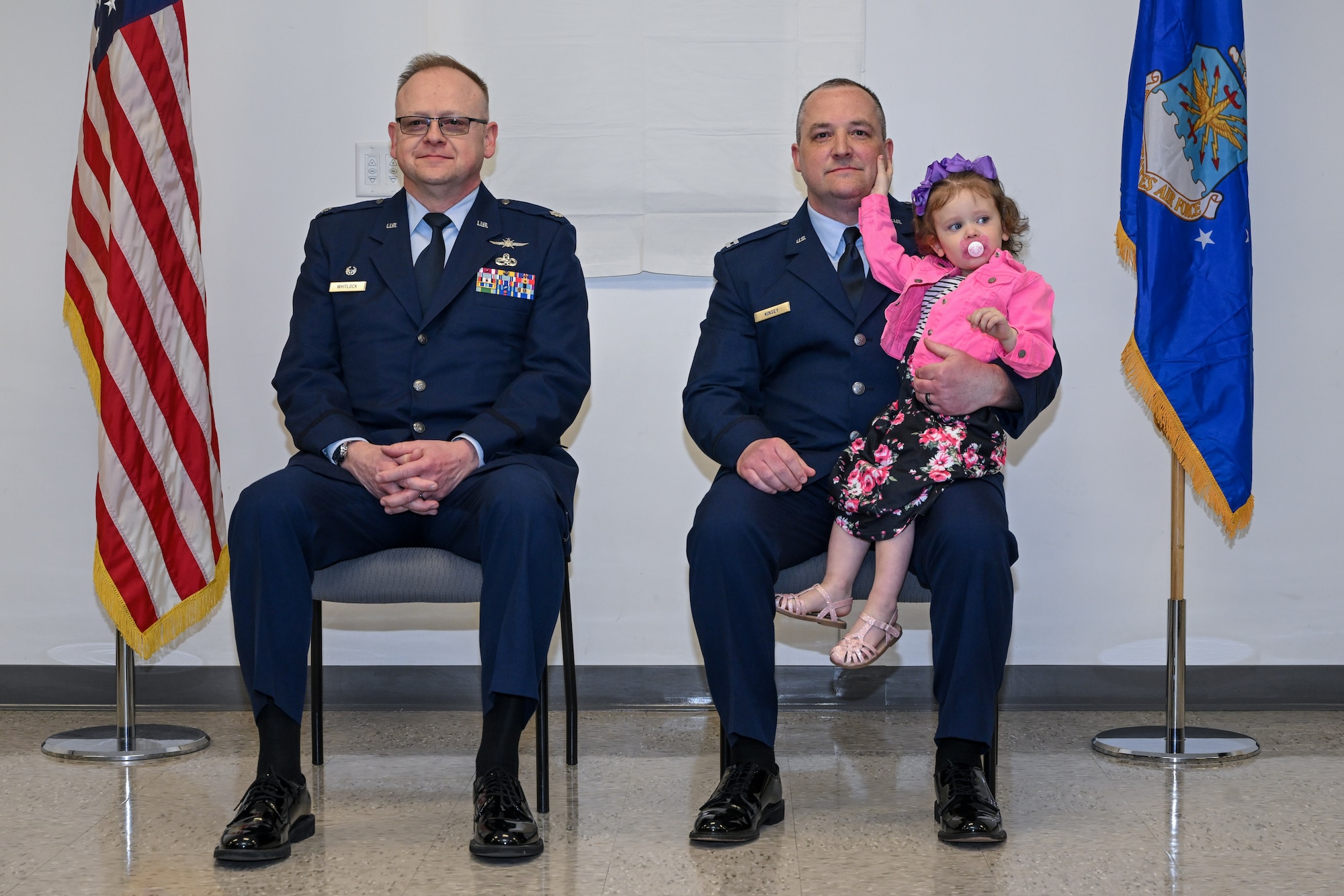 Lt. Col. Russell Whitlock, 910th Mission Support Group commander, and Capt. Jeffrey Kinsey, 910th Logistics Readiness Squadron commander, listen to opening remarks during the assumption of command ceremony at Youngstown Air Reserve Station, Ohio, April 6, 2024.
