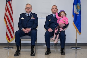 Lt. Col. Russell Whitlock, 910th Mission Support Group commander, and Capt. Jeffrey Kinsey, 910th Logistics Readiness Squadron commander, listen to opening remarks during the assumption of command ceremony at Youngstown Air Reserve Station, Ohio, April 6, 2024.