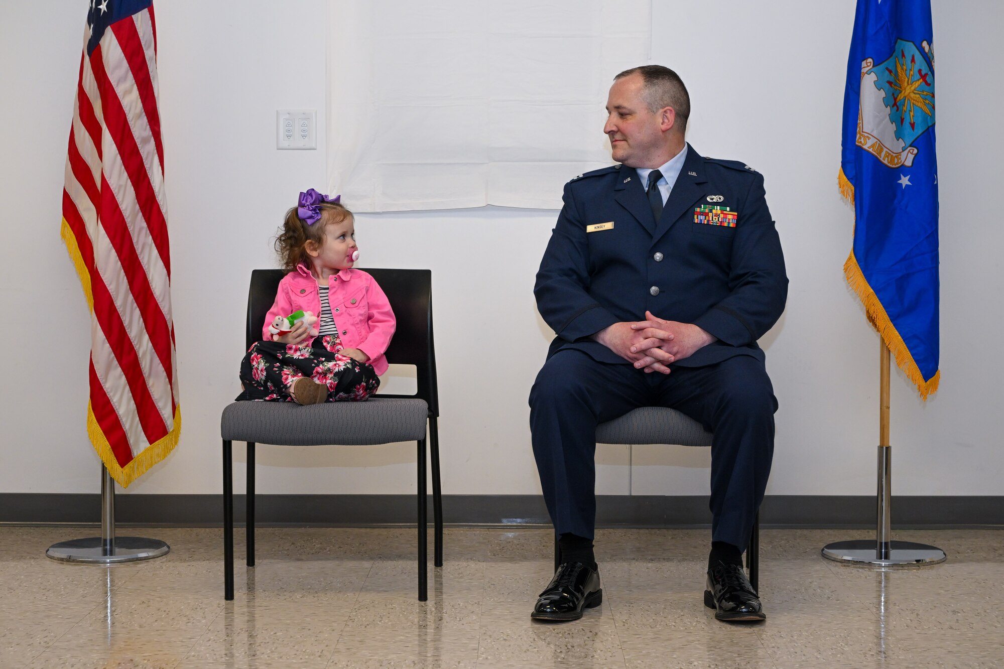 Capt. Jeffrey Kinsey, 910th Logistics Readiness Squadron commander, locks eyes with his youngest daughter during the opening remarks of his assumption of command ceremony at Youngstown Air Reserve Station, Ohio, April 6, 2024.