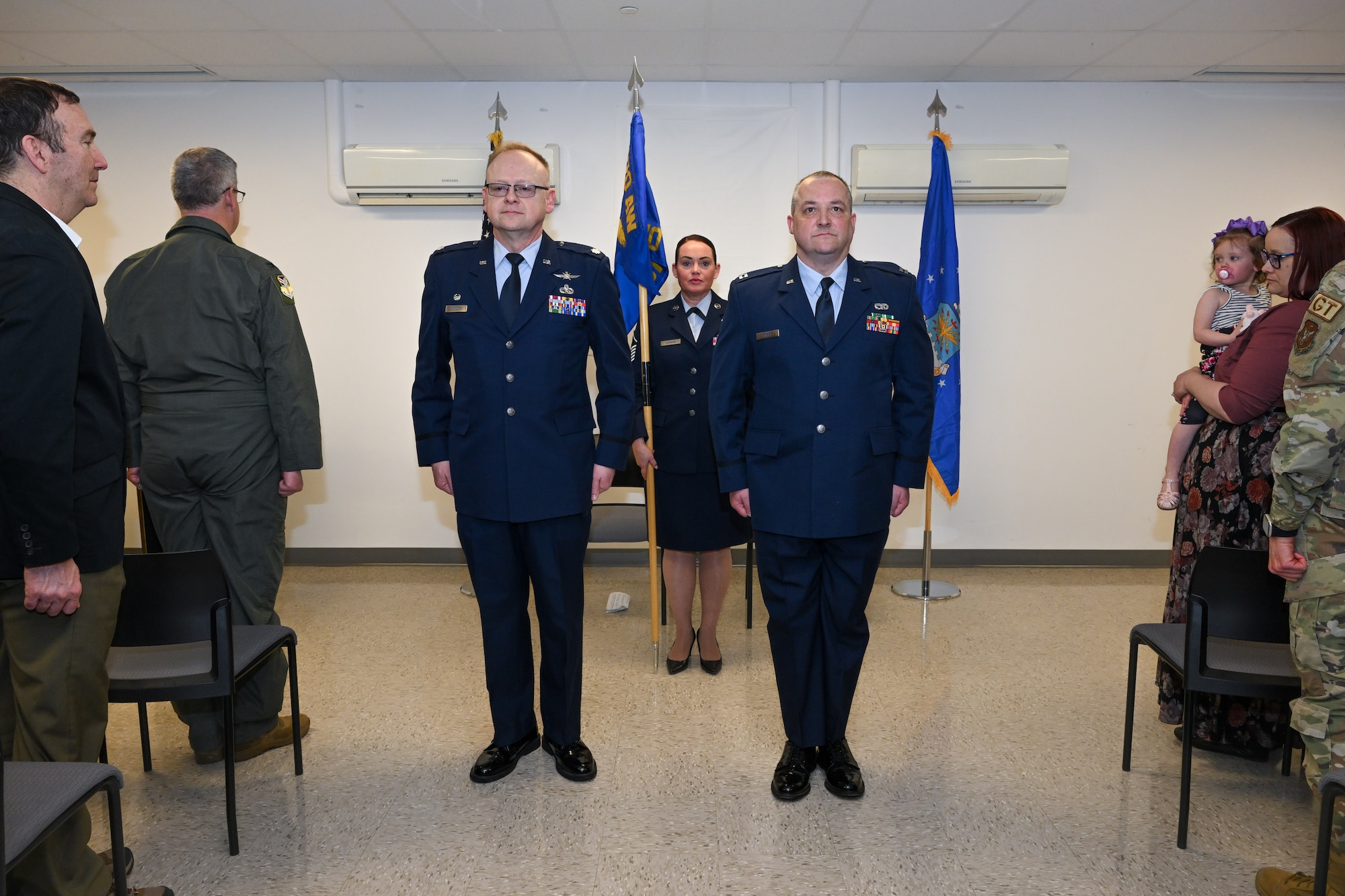 Lt. Col. Russell Whitlock, 910th Mission Support Group commander, and Capt. Jeffrey Kinsey, 910th Logistics Readiness Squadron commander, stand at attention during the assumption of command ceremony at Youngstown Air Reserve Station, Ohio, April 6, 2024.