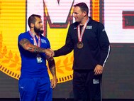 U.S. Army SSG Ross Alewine, right, is congratulated by Silver Medalist U.S. Air Force SrA Rafael Morfinenciso, center, and Bronze Medalist U.S. Army SSG Altermese Kendrick after Alewine won the Gold Medal as Ultimate Champion during the Closing Ceremony at the 2018 Department of Defense Warrior Games.