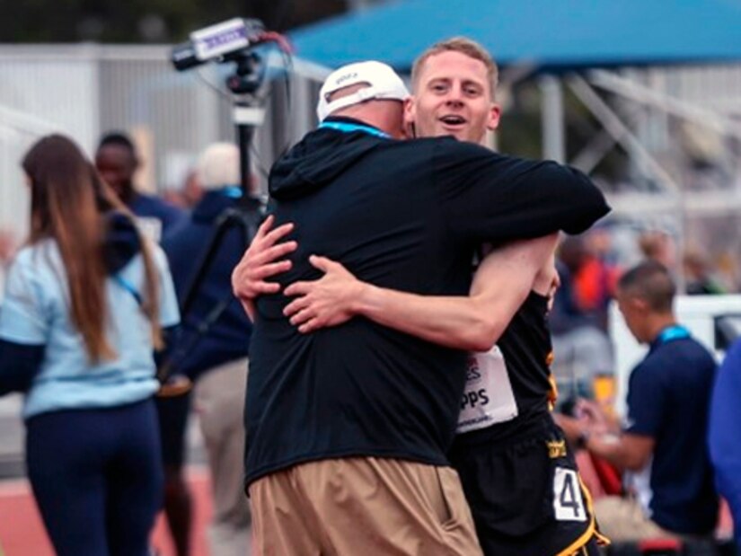 Team Army Coach Chris Uggiano embraces U.S. Army Spc. Timothy Capps after finishing his race on June 6, 2023, during the Department of Defense Warrior Games Challenge. (U.S. Army photo by Sgt. Anthony Hopper)