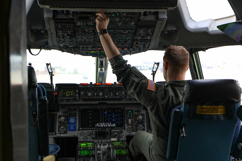A U.S. Air Force pilot assigned to the 305th Air Mobility Wing performs pre-flight checks in a C-17 Globemaster III at Joint Base McGuire-Dix-Lakehurst, N.J., March 15, 2024. The 305th Air Mobility Wing recently conducted the first-ever locally hosted training exercise showcasing advanced airborne mobility mission management marking a significant leap forward in Air Mobility Command's ability to deliver precision effects swiftly and effectively. (U.S. Air Force photo by Rochelle Naus)