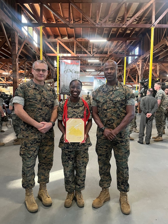 From left, U.S. Marine Corps Col. Jeremie Hester, commanding officer of Marine Aircraft Group 39, 3rd Marine Aircraft Wing; Cpl. Celia G. Flomo, a supply clerk with MAG-39; and Sgt. Maj. Idris Turay, sergeant major of MAG-39; pose for a photo after a meritorious promotion ceremony for Flomo at Marine Corps Air Station Camp Pendleton, California, March 25, 2024. Flomo was meritoriously promoted to the rank of corporal for demonstrating exceptional leadership, knowledge, and physical fitness, and standing out amongst her peers while taking on the responsibilities and duties of a higher grade. (Courtesy photo)