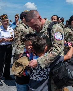 Master Sgt. Javier Pino, 482d Medical Squadron, is joyfully reunited with his sons at Homestead Air Reserve Base, Florida,  April 3, 2024.