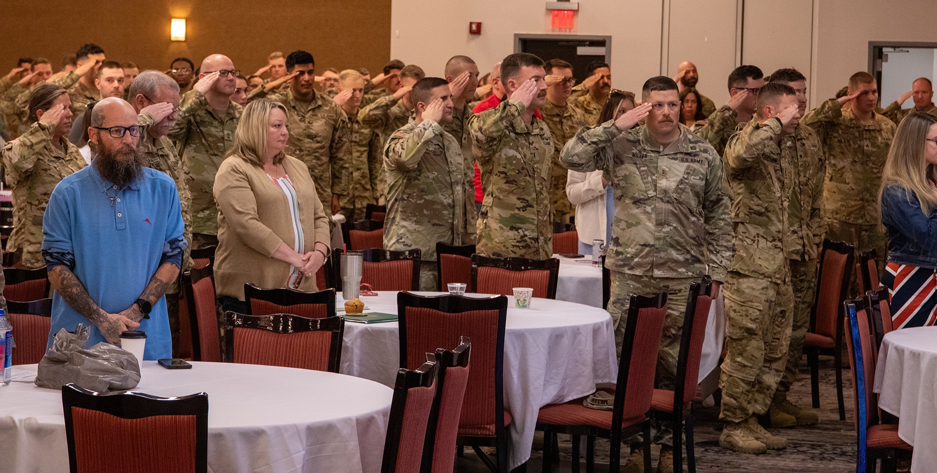 Soldiers from 1st Battalion, 106th Aviation Regiment, based in Peoria, and Company B, 935th Aviation Support Battalion, based in Kanakee, salute during a welcome home ceremony April 13 in Bloomington.