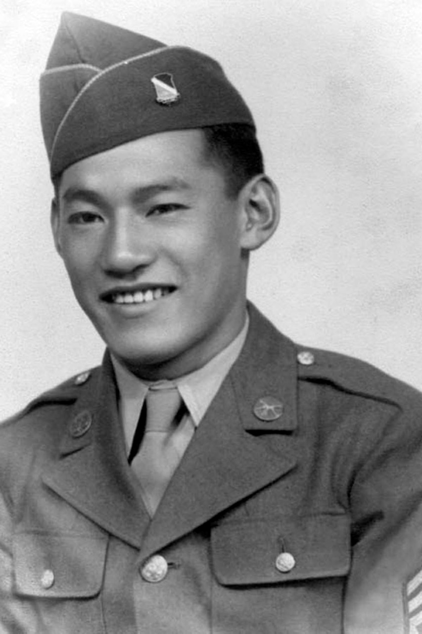 A person in a military uniform poses for a photo.