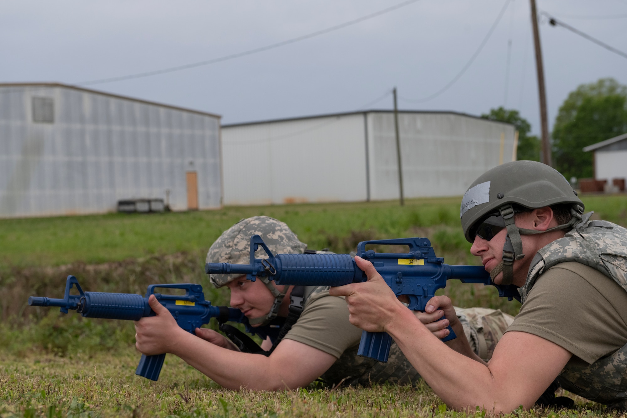 U.S. Air Force Senior Airman Kyle Neece, right, and Senior Airman Tristan Barbour, 23rd Munition Squadron conventional maintenance crew chiefs, provide security at Perry-Houston County Airport, Georgia, during Exercise Ready Tiger 24-1, April 10, 2024. Despite their varied roles, Airmen assumed the responsibilities of security forces augmentees to ensure the protection of aircraft and personnel on the flight line. During Ready Tiger 24-1, the 23rd Wing will be evaluated on the integration of Air Force Force Generation principles such as Agile Combat Employment, integrated combat turns, forward aerial refueling points, multi-capable Airmen, and combat search and rescue capabilities. (U.S. Air Force photo by Senior Airman Rachel Coates)