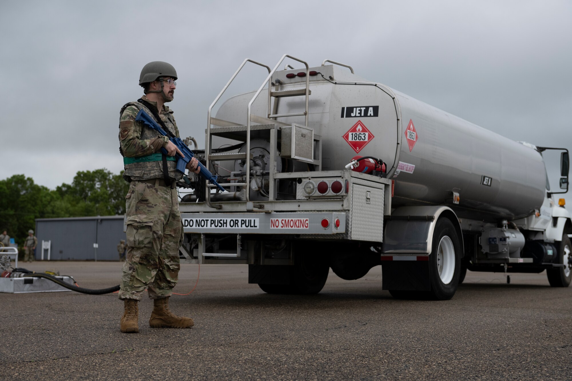 U.S. Air Force Senior Airman Chad Tidwell, 23rd Logistics Readiness Squadron fuels distribution supervisor, guards a fuel truck during Exercise Ready Tiger 24-1 at Perry-Houston County Airport, Georgia, April 11, 2024. Airmen from various specialties assumed base defense roles, encapsulating the Multi-Capable Airmen concept to ensure the success of generating combat airpower in contingency locations. Ready Tiger 24-1 is a readiness exercise demonstrating the 23rd Wing’s ability to plan, prepare and execute operations and maintenance to project air power in contested and dispersed locations, defending the United States’ interests and allies. (U.S. Air Force photo by Senior Airman Rachel Coates)