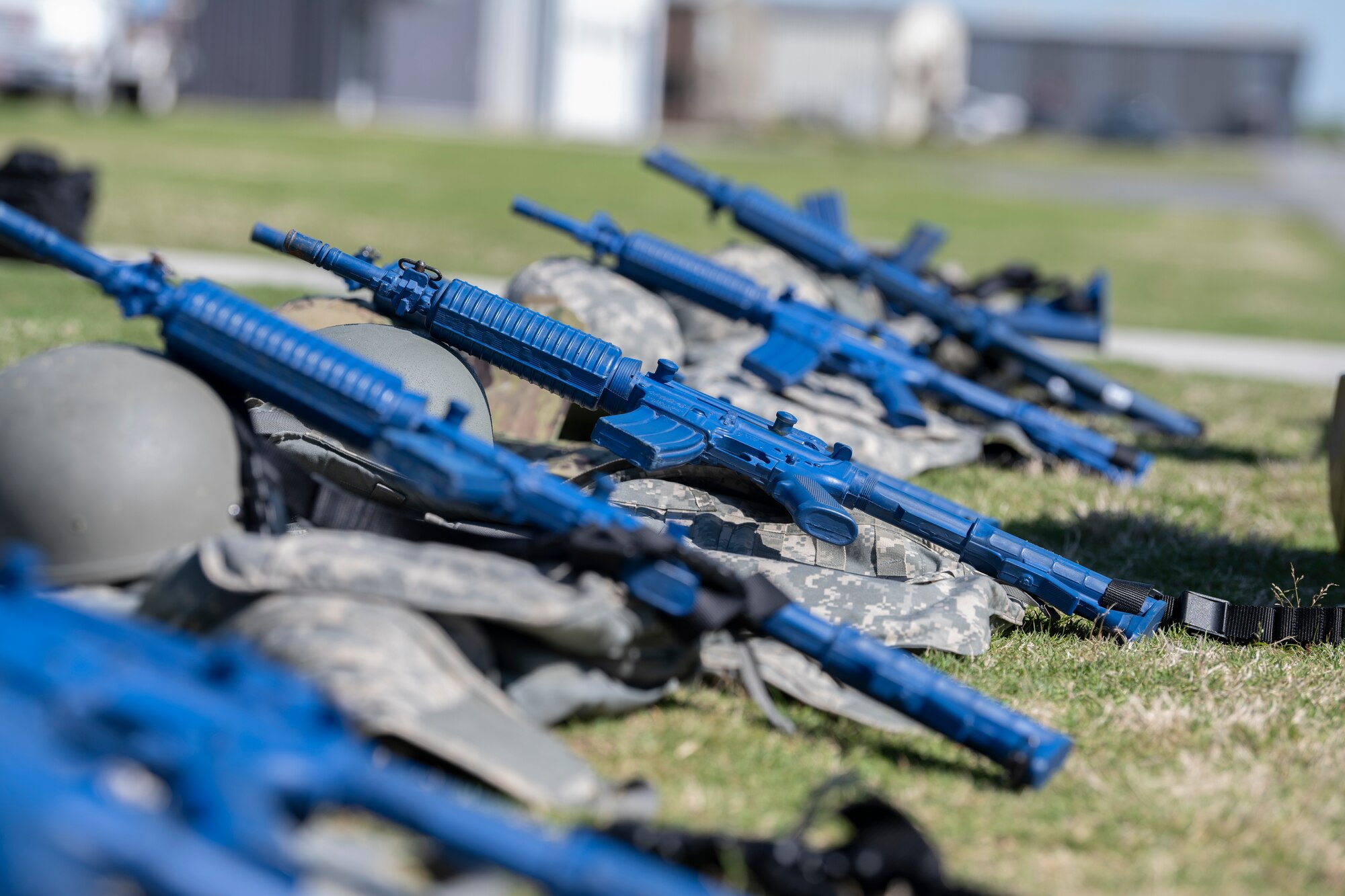 M-4 carbine training weapons lay on personal protective equipment at Perry-Houston County Airport, Georgia, April 12, 2024. Throughout Exercise Ready Tiger 24-1, Airmen wore personal protective equipment to authentically replicate the experience of deploying into real-world scenarios. During Ready Tiger 24-1, the 23rd Wing will be evaluated on the integration of Air Force Force Generation principles such as Agile Combat Employment, integrated combat turns, forward aerial refueling points, multi-capable Airmen, and combat search and rescue capabilities. (U.S. Air Force photo by Senior Airman Rachel Coates)
