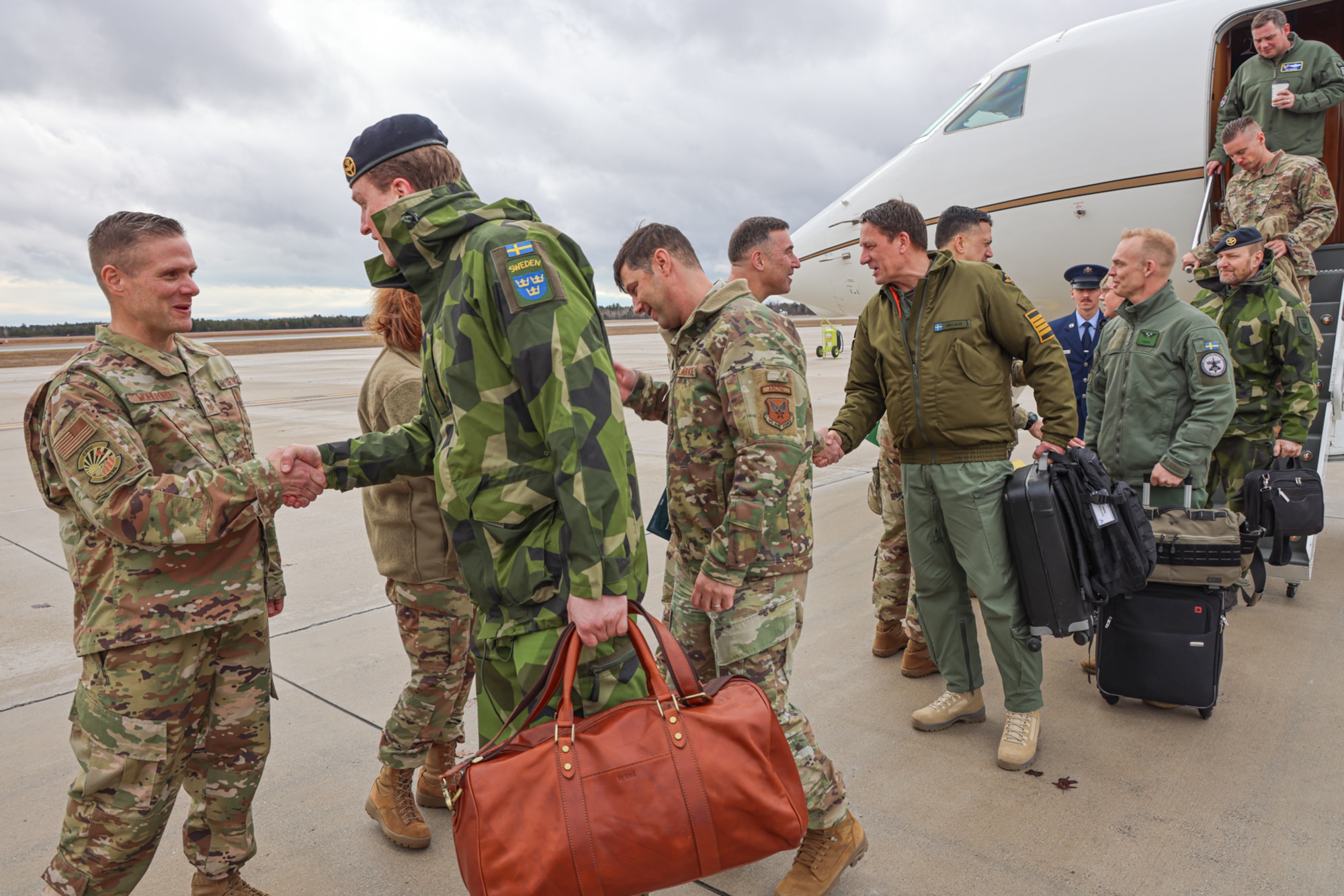 Members of Headquarters Air Force (HAF) and Swedish Air Force are greeted by leadership from the Michigan National Guard (MING) at the Alpena Combat Readiness Training Center, Michigan, on April 3rd, 2024. The Michigan National Guard hosted members of Headquarters Air Force and Swedish Air Force at the National All Domain Warfighting Center (NADWC) on April 3-4, 2024. The visit gave those attending a look at training venues and opportunities offered at the NADWC in Michigan. (U.S. Air National Guard photo by Tech. Sgt. Drew Schumann)
