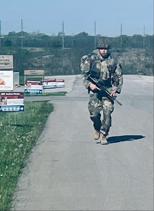 Spc. Mark Meyers completes the 12-mile road march during the Illinois Army National Guard’s Best Warrior Competition, April 12-14, at Sparta Training Area in Sparta, Illinois.