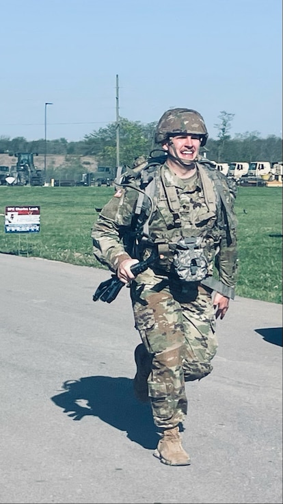 Spc. Nicholas Hester completes the 12-mile road march during the Illinois Army National Guard’s Best Warrior Competition, April 12-14, at Sparta Training Area in Sparta, Illinois.