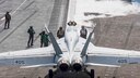 Sailors guide an F/A-18F Super Hornet from the "Knighthawks" of Strike Fighter Squadron (VFA) 136 to a catapult on the flight deck of the Nimitz-class aircraft carrier USS Harry S. Truman (CVN 75).