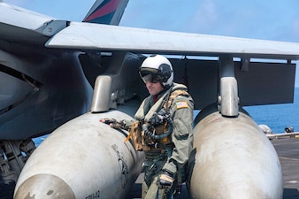 Capt. Brian Schrum, commanding officer of the Nimitz-class aircraft carrier USS Theodore Roosevelt (CVN 71), inspects an F/A-18E Super Hornet from the "Black Knights" of Strike Fighter Squadron (VFA) 154 aboard Theodore Roosevelt.