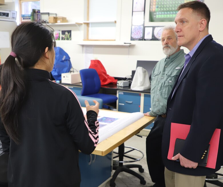 Dr. Ivan Beckman (right), acting director of ERDC’s Cold Regions Research and Engineering Laboratory (CRREL), and New Hampshire Academy of Science (NHAS) Executive Director Dr. Peter Faletra (middle) listen as a NHAS student explains her recent research.