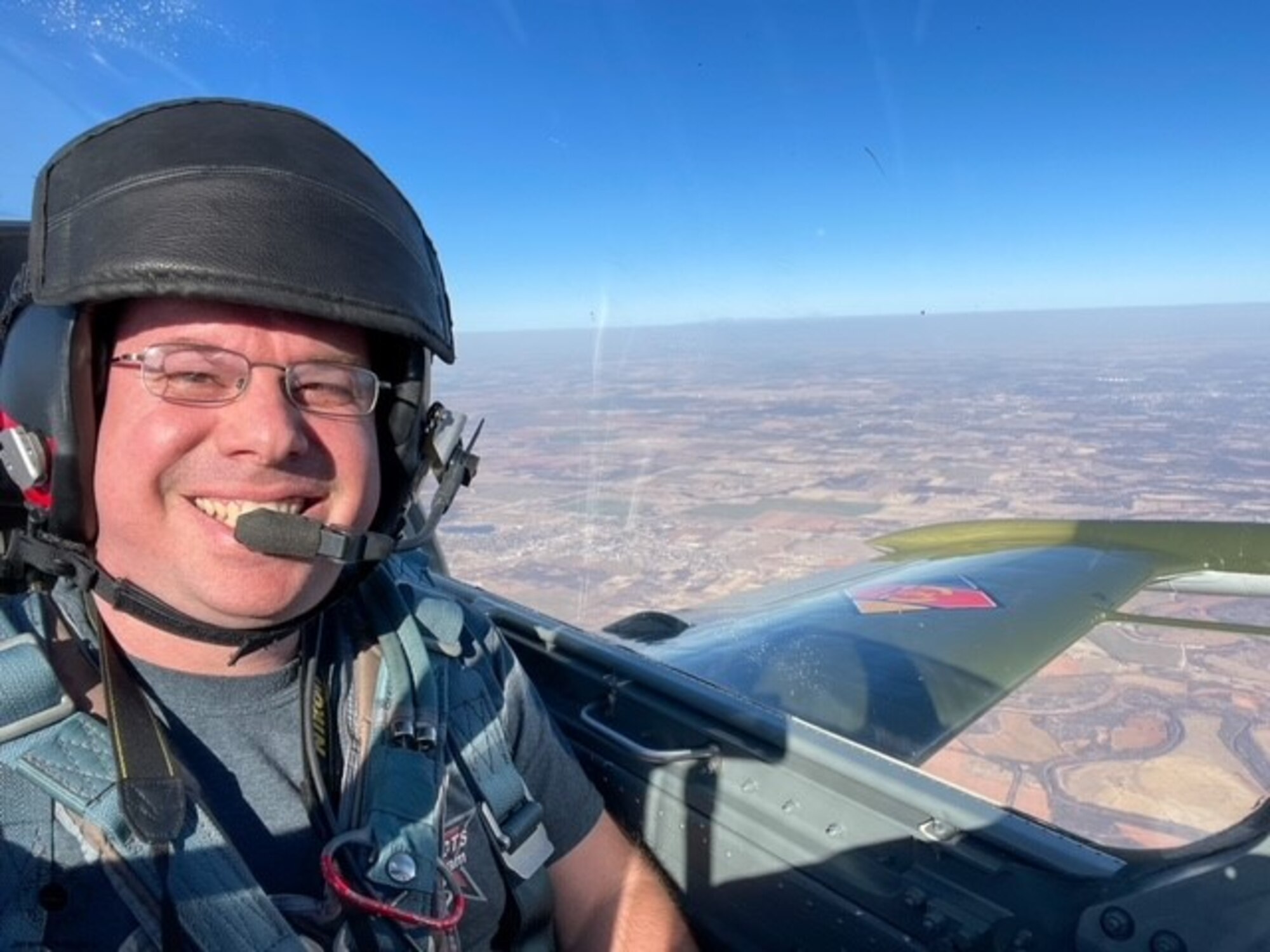 A man smiles in a cockpit