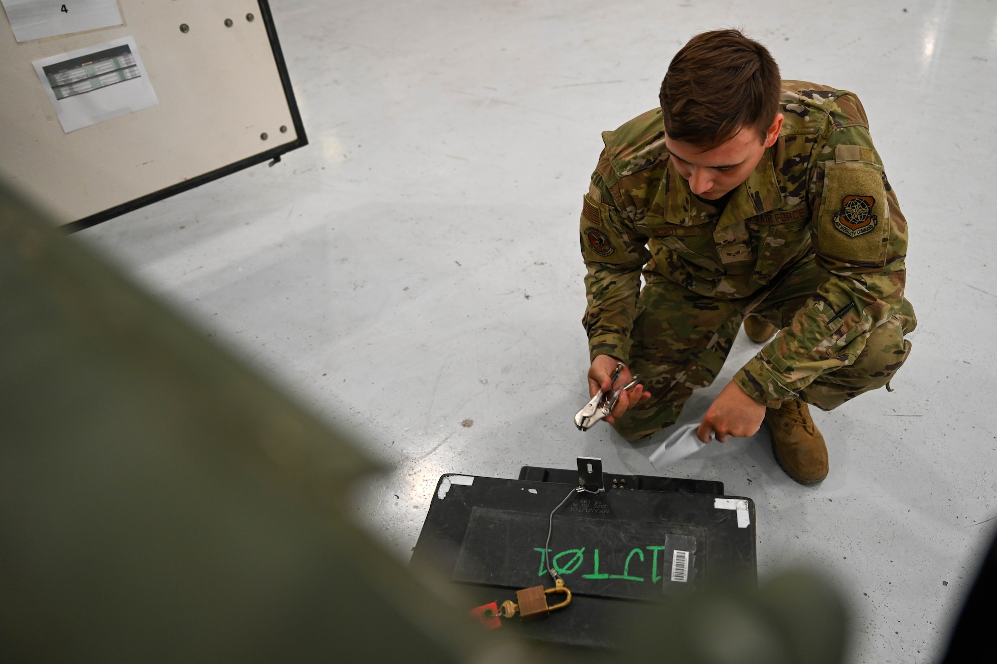 Senior Airman Devon Moody, 22nd Maintenance Squadron aerospace maintenance journeyman, opens a toolbox during a weather relocation at McConnell Air Force Base, Kansas, April 15, 2024. Due to the possibility of high winds and hail, the majority of McConnell’s aircraft left the base for a weather relocation. (U.S. Air Force photo by Airman 1st class William Lunn)
