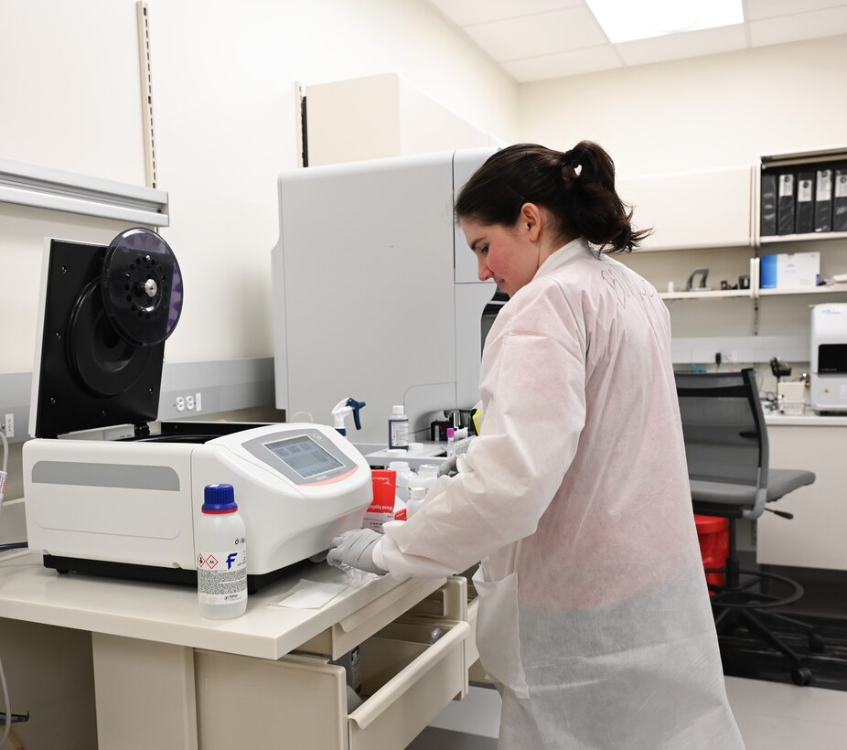 Airman 1st Class Megan Bowden, lab specialist, performs slide stainer maintenance.