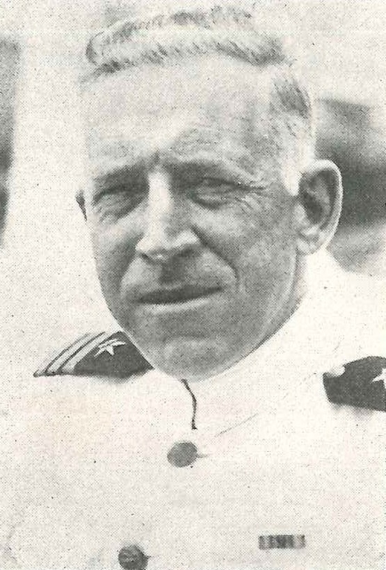 A black-and-white photograph shows John L. Hall, Jr., wearing his service dress white uniform with a Commander’s shoulder boards, circa 1937