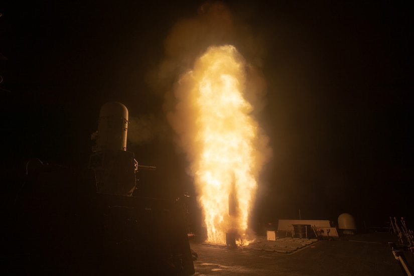 A missile launches from a Navy ship at sea.