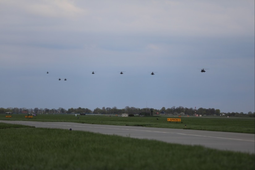 Helicopters fly in formation.