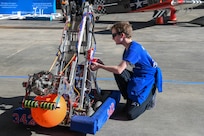 A photo of a person looking at a STEM display.