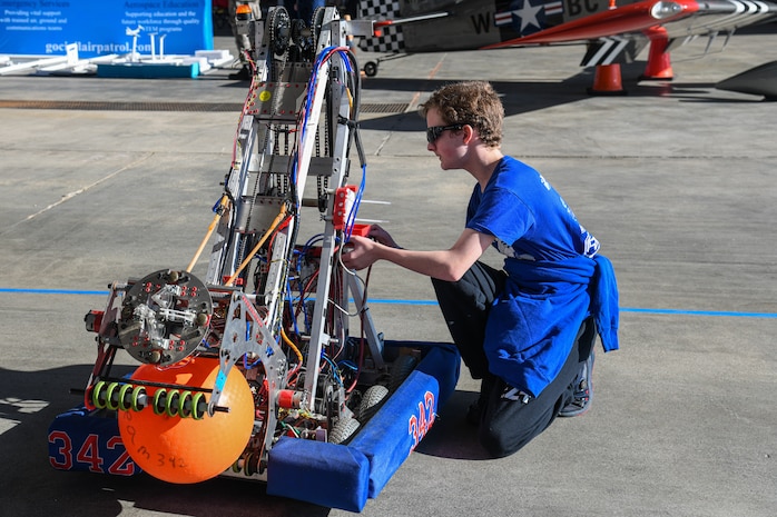 A photo of a person looking at a STEM display.