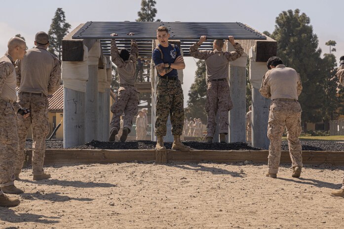 U.S. Marine Corps Sgt. Trace Gresham, a drill instructor with Lima Company, 3rd Recruit Training Battalion, observes recruits conducting the confidence course at Marine Corps Recruit Depot San Diego, California, April 11, 2024. The confidence course allows recruits to become physically and mentally stronger by overcoming obstacles that require strength, balance, and determination. (U.S. Marine Corps photo by Lance Cpl. Alexandra M. Earl)
