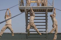 U.S. Marine Corps recruits with Lima Company, 3rd Recruit Training Battalion, maneuver an obstacle during the confidence course at Marine Corps Recruit Depot San Diego, California, April 11, 2024. The confidence course allows recruits to become physically and mentally stronger by overcoming obstacles that require strength, balance, and determination. (U.S. Marine Corps photo by Lance Cpl. Alexandra M. Earl)