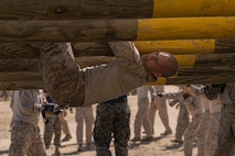 U.S. Marine Corps Recruit Kenneth Bezotte with Lima Company, 3rd Recruit Training Battalion, maneuvers an obstacle during the confidence course at Marine Corps Recruit Depot San Diego, California, April 11, 2024. The confidence course allows recruits to become physically and mentally stronger by overcoming obstacles that require strength, balance, and determination. (U.S. Marine Corps photo by Lance Cpl. Alexandra M. Earl)