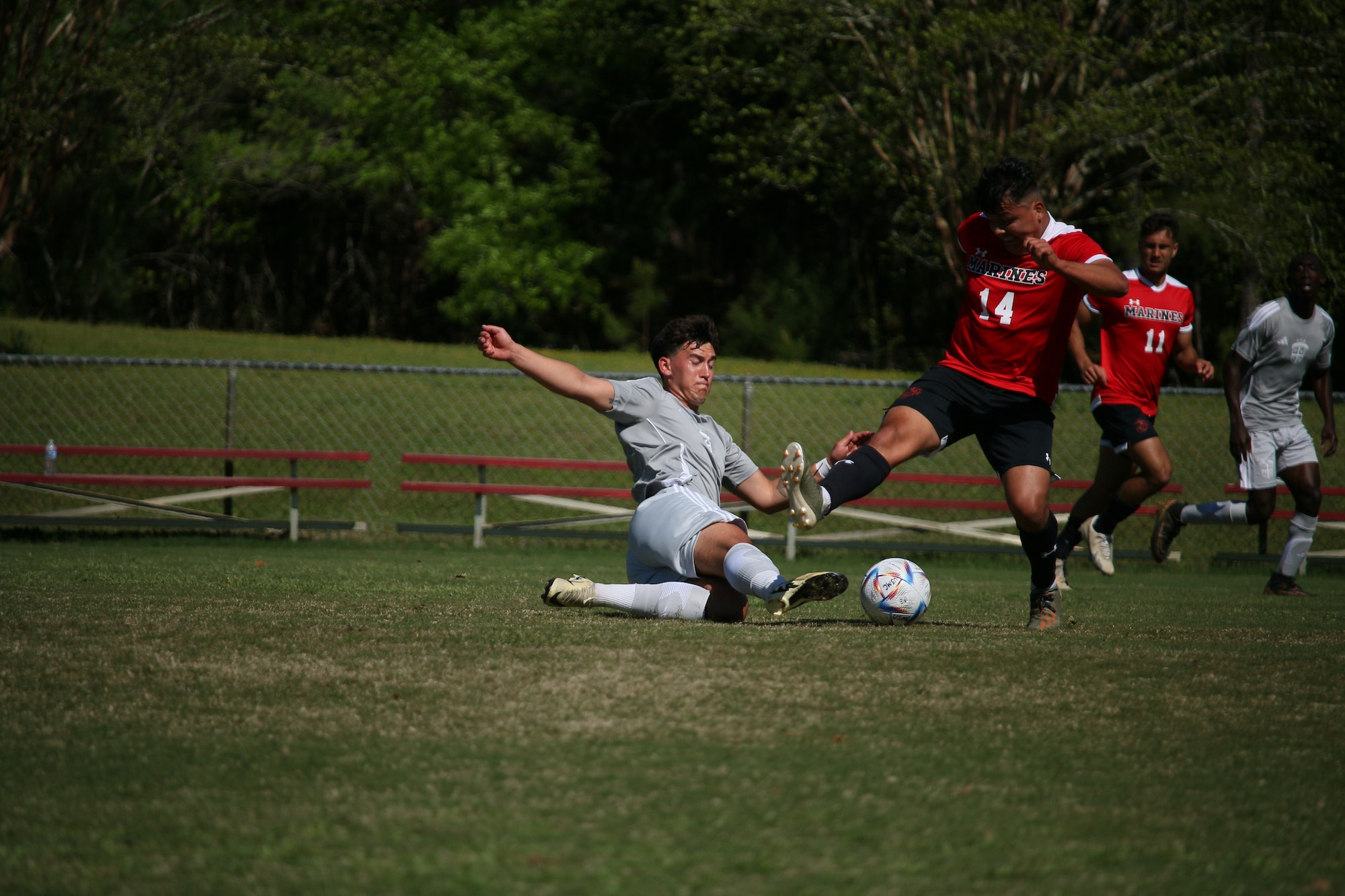 Lt. Keenan Sweeney dives to save a soccer ball while a member of the opposite team tries to kick the ball at the 2024 Armed Forces Men's Soccer Championship.