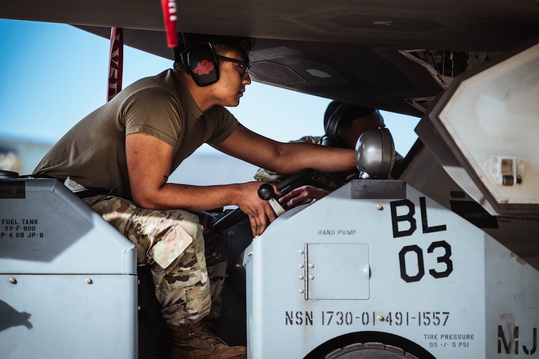 U.S. Air Force Staff Sgt. Paolo Silva, 63rd Aircraft Maintenance Unit weapons load crew member, navigates a jammer during the annual weapons load competition, Feb. 9, 2024, at Luke Air Force Base, Arizona.