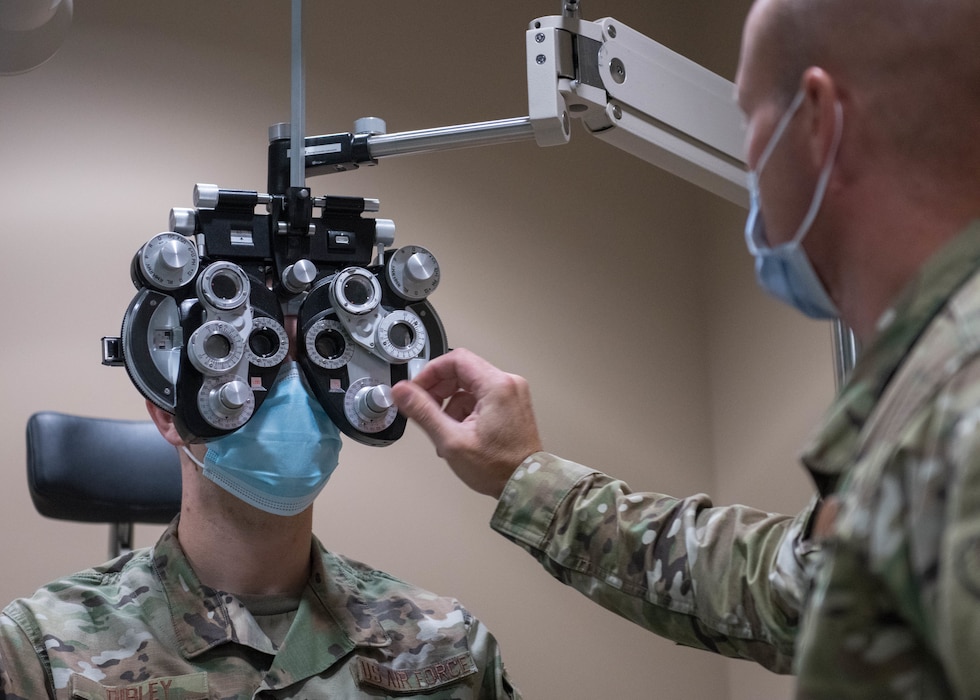 Lt. Col. Michael Bogaard, 56th Operational Medical Readiness Squadron optometrist (right), adjusts the prescription on a phoropter for a patient May 9, 2020, at Luke Air Force Base, Arizona.