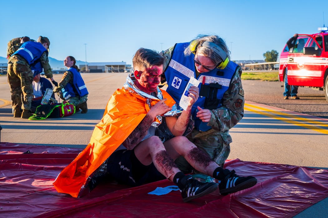 U.S. Air Force Capt. Nakia Halcom, 56th Medical Group registered nurse, simulates treating patient during a mass casualty exercise, Feb. 21, 2024, at Luke Air Force Base, Arizona.