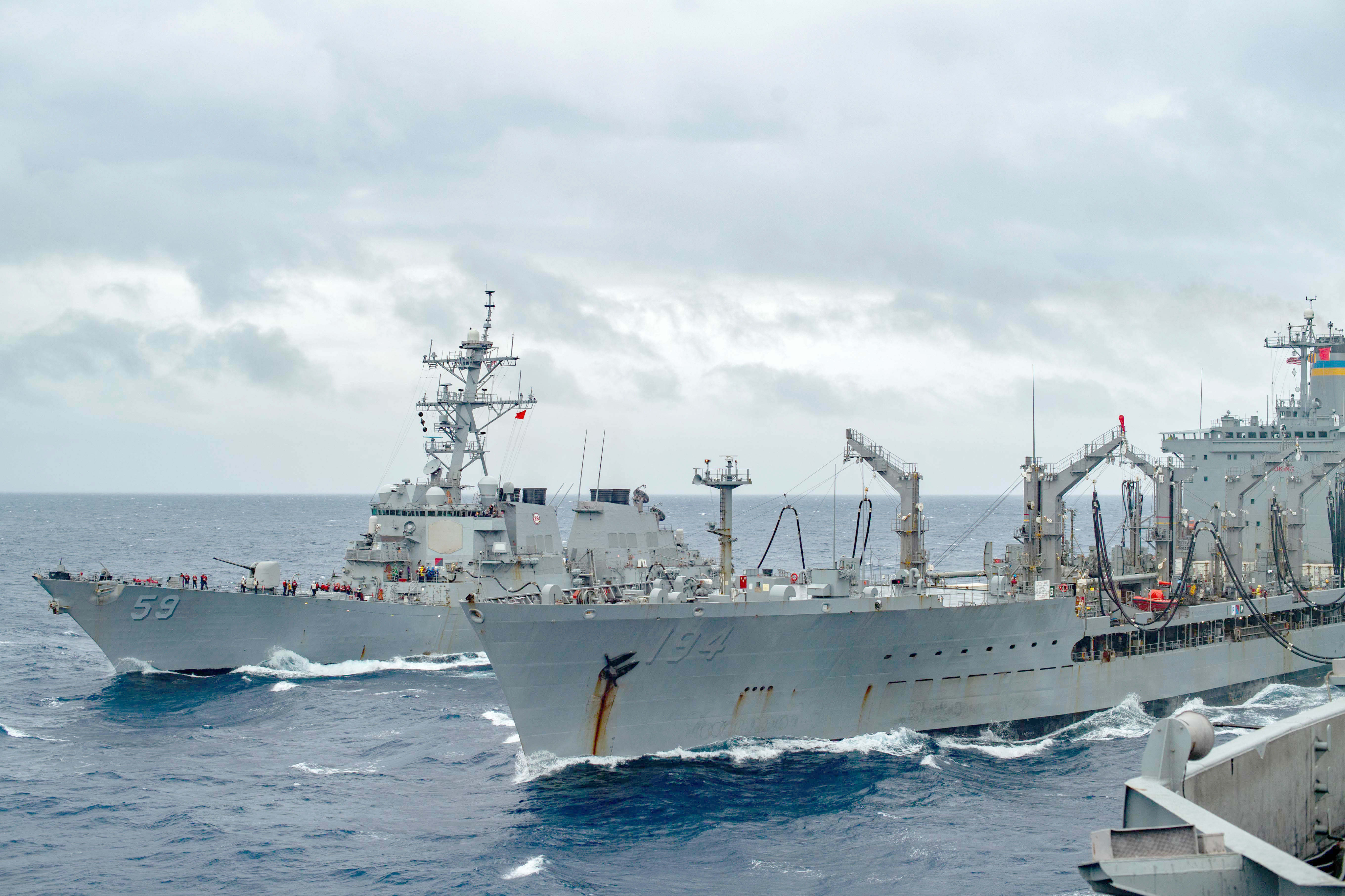 USNS John Ericsson (T-AO 194), right, and USS Russell (DDG 59) sail alongside USS Theodore Roosevelt (CVN 71) during a fueling-at-sea.