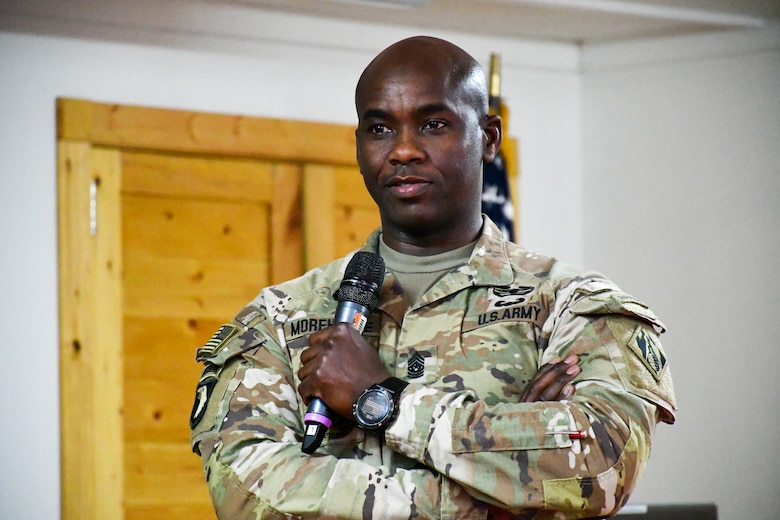U.S. Army command sergeant major holding microphone.