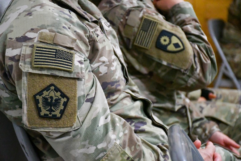Close-up of deployment patches on U.S. Army uniform.