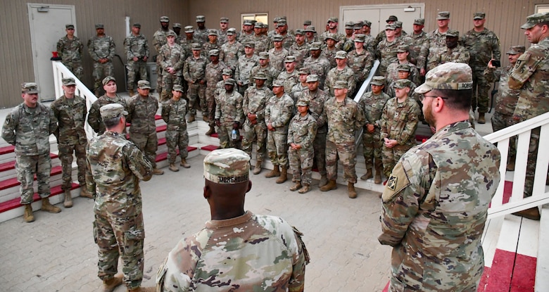 Army sergeant major talks to group of engineer Soldiers.