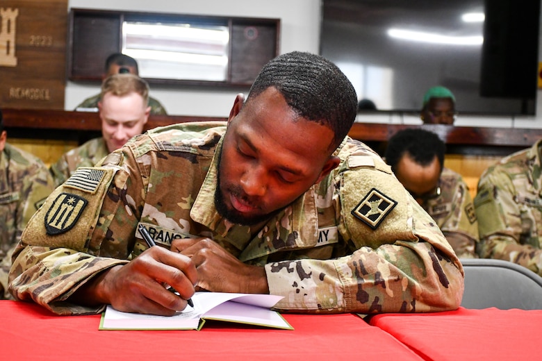 Soldier writes in notebook.