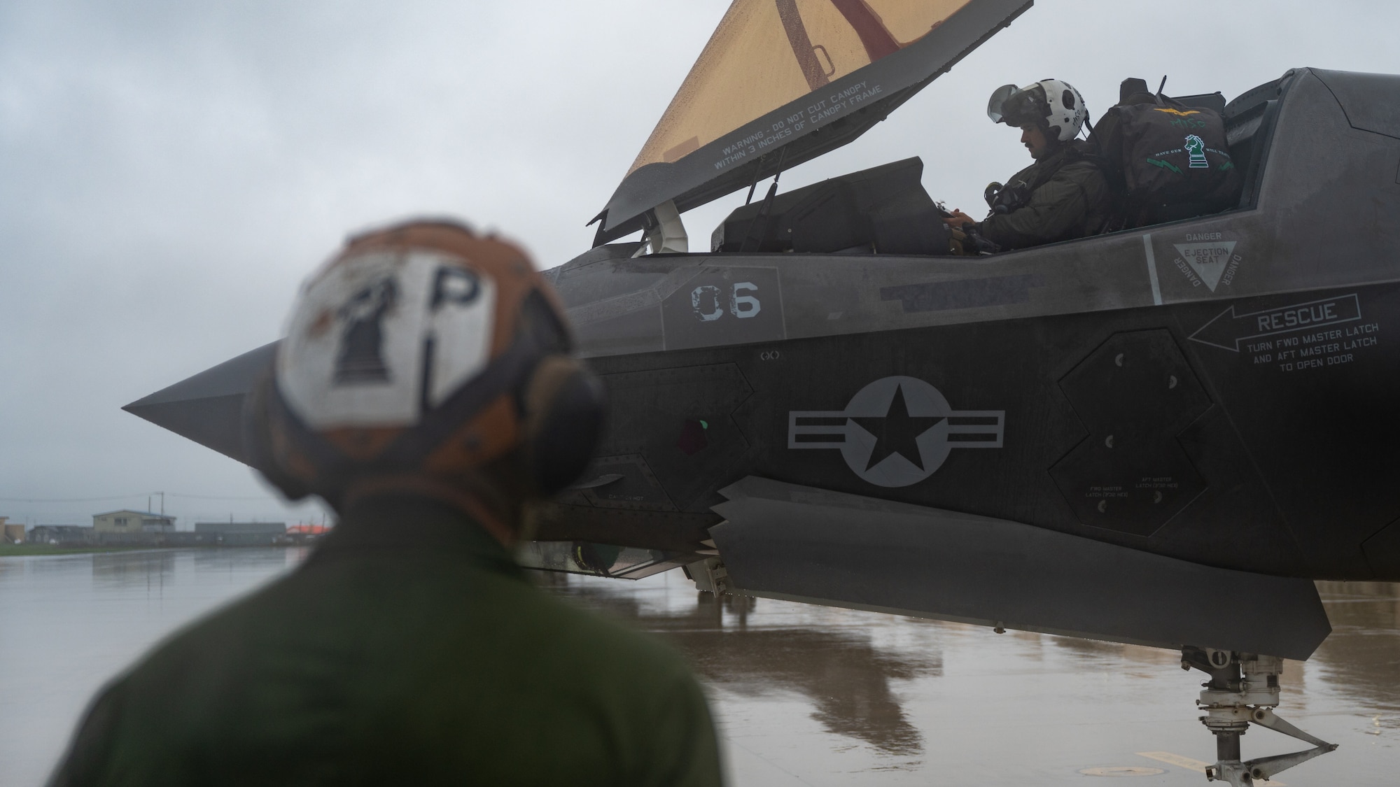 U.S. Marine Corps Cpl. Tanis Pendleton, 121st Marine Fighter Attack Squadron power liner mechanic, stands by while U.S. Marine Corps Capt. Cameron Caldwell,  F-35 Lightning II pilot, completes final preparation before taking off