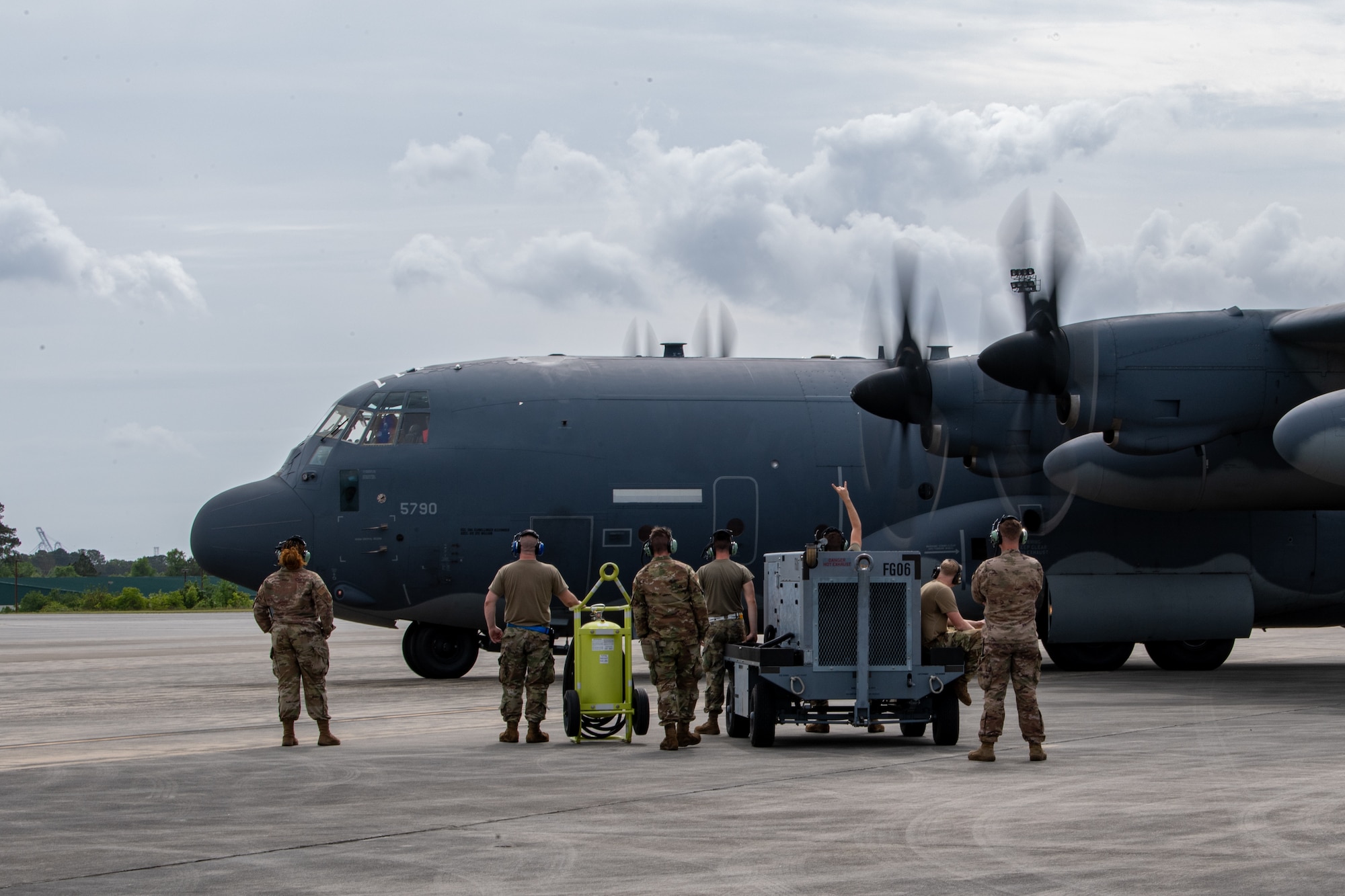 U.S. Air Force Airmen assigned to the 23rd Wing watch as an HC-130J Combat King II starts engines during Exercise Ready Tiger 24-1 at Savannah Air National Guard Base in Savannah, Georgia, April 10, 2024. Built upon Air Combat Command's directive to assert air power in contested environments, Exercise Ready Tiger 24-1 aims to test and enhance the 23rd Wing’s proficiency in executing Lead Wing and Expeditionary Air Base concepts through Agile Combat Employment and command and control operations. (U.S. Air Force photo by Senior Airman Courtney Sebastianelli)