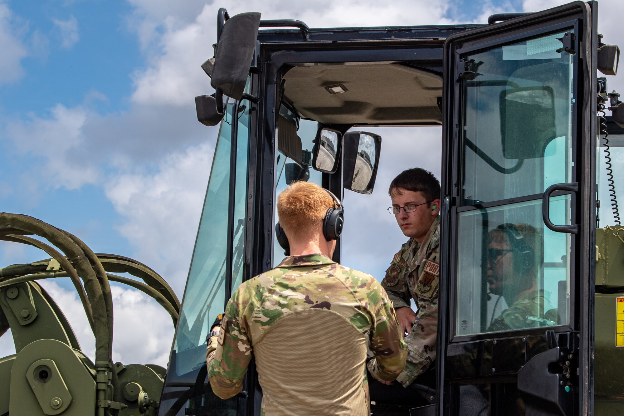 U.S. Air Staff Sgt. Brendan Hellbusch, 23rd Logistics Readiness Squadron air transportation specialist, listens to Airman 1st Class Blake Daggy, 71st Rescue Squadron loadmaster, during Exercise Ready Tiger 24-1 at Savannah Air National Guard Base, Georgia, April 10, 2024. During Ready Tiger 24-1, the 23rd Wing will be evaluated on the integration of Air Force Force Generation principles such as Agile Combat Employment, integrated combat turns, forward aerial refueling points, multi-capable Airmen, and combat search and rescue capabilities. (U.S. Air Force photo by Senior Airman Courtney Sebastianelli)