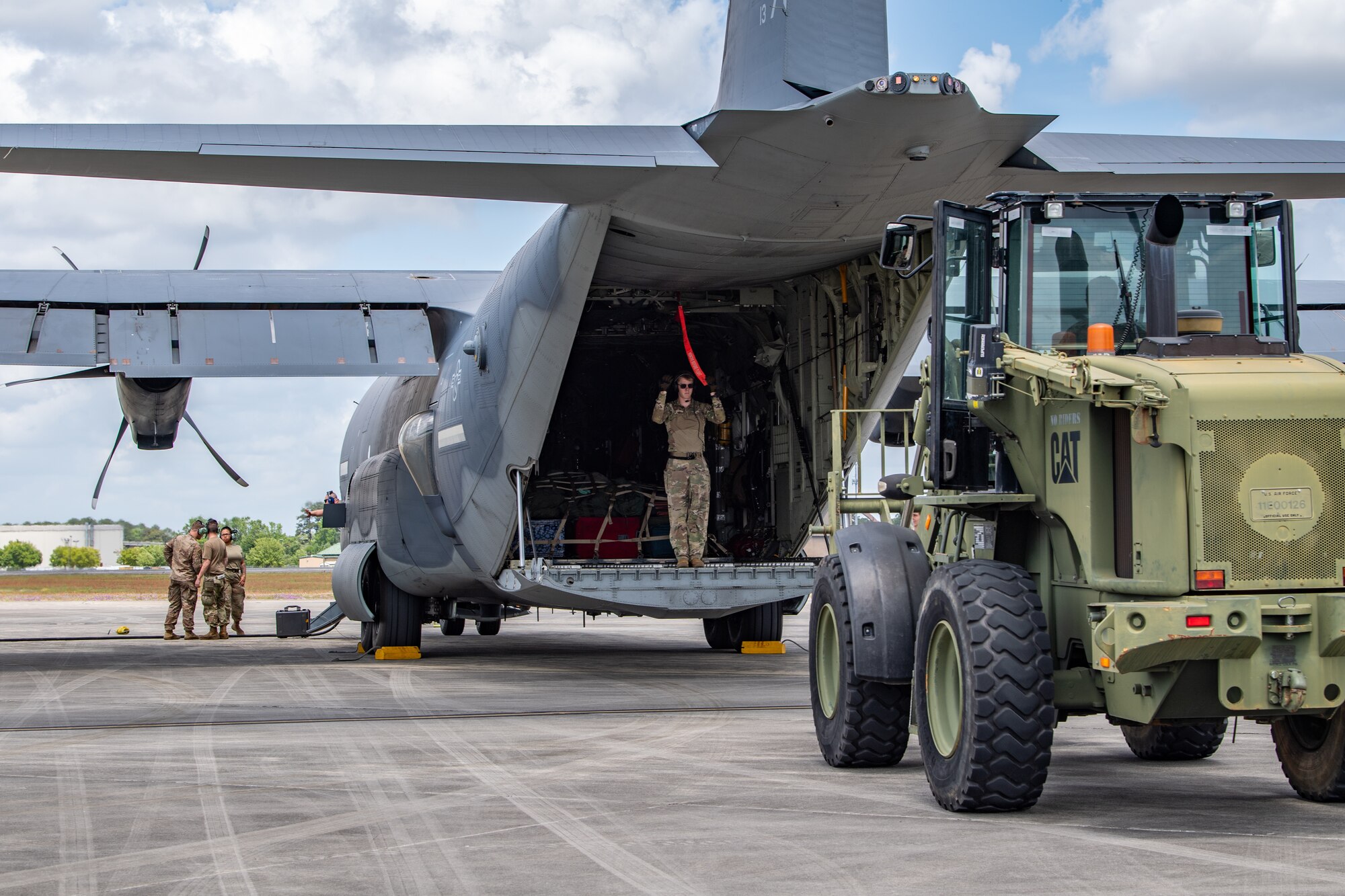 U.S. Air Force Airman 1st Class Blake Daggy, 71st Rescue Squadron loadmaster, directs a forklift to offload cargo during Exercise Ready Tiger 24-1 at Savannah Air National Guard Base, Georgia, April 10, 2024. The 71st RQS provided essential airlift support for transporting cargo and personnel and responded to combat search and rescue scenarios throughout the exercise. During Ready Tiger 24-1, the 23rd Wing will be evaluated on the integration of Air Force Force Generation principles such as Agile Combat Employment, integrated combat turns, forward aerial refueling points, multi-capable Airmen, and combat search and rescue capabilities. (U.S. Air Force photo by Senior Airman Courtney Sebastianelli)