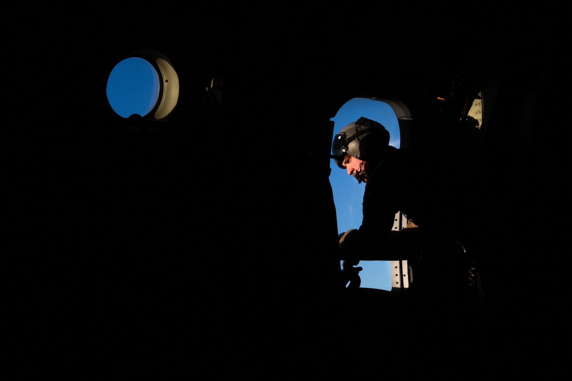 U.S. Air Force Staff Sgt. Todd Truran, 71st Rescue Squadron instructor loadmaster, looks out the bubble door of an HC130J Combat King II during Exercise Ready Tiger 24-1 at Savannah Air National Guard Base, Georgia, April 12, 2024. Throughout the exercise, aircrew simulated real-world responses to combat search and rescue missions. During Ready Tiger 24-1, exercise inspectors will assess the 23rd Wing's proficiency in employing decentralized command and control to fulfill air tasking orders across geographically dispersed areas amid communication challenges, integrating Agile Combat Employment principles such as integrated combat turns, forward aerial refueling points, multi-capable Airmen, and combat search and rescue capabilities. (U.S. Air Force photo by Senior Airman Courtney Sebastianelli)