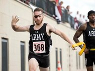 Visually impaired runner Ret. Army Spc. Michael Stephens (l) finishes a race with his guide, Ret. Army Sgt. 1st Class Adam Blow, during the 2017 Department of Defense Warrior Games in Chicago.