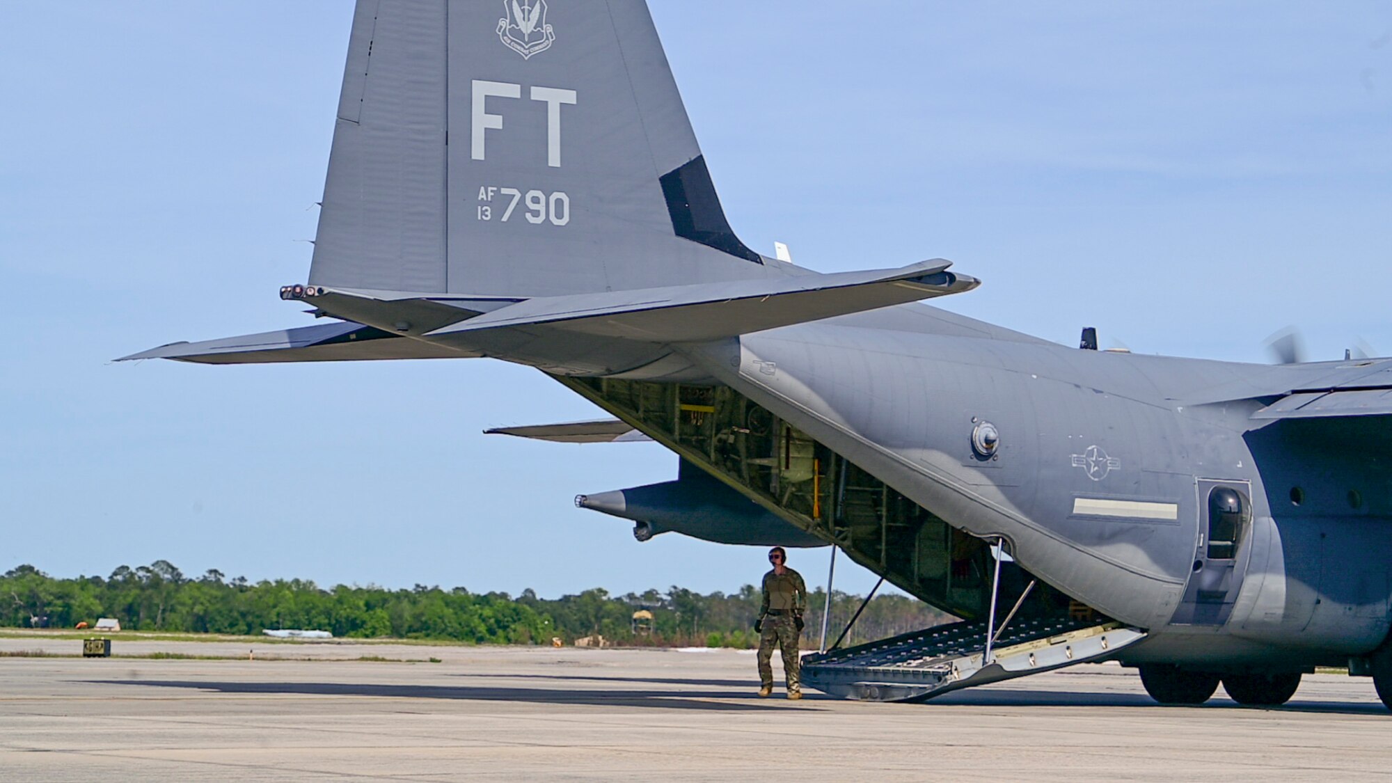 A U.S Air Force loadmaster assigned to the 71st Rescue Squadron prepares to load personnel and cargo onto an HC-130J Combat King II  during Exercise Ready Tiger 24-1 at Moody Air Force Base, Georgia, April 8, 2024. Loadmasters are responsible for supervising the loading and unloading of cargo, vehicles and people on a variety of aircraft. During Ready Tiger 24-1, exercise inspectors will assess the 23rd Wing's proficiency in employing decentralized command and control to fulfill air tasking orders across geographically dispersed areas amid communication challenges, integrating Agile Combat Employment principles such as integrated combat turns, forward aerial refueling points, multi-capable Airmen, and combat search and rescue capabilities. (U.S. Air Force photo by 2nd Lt. Benjamin Williams)