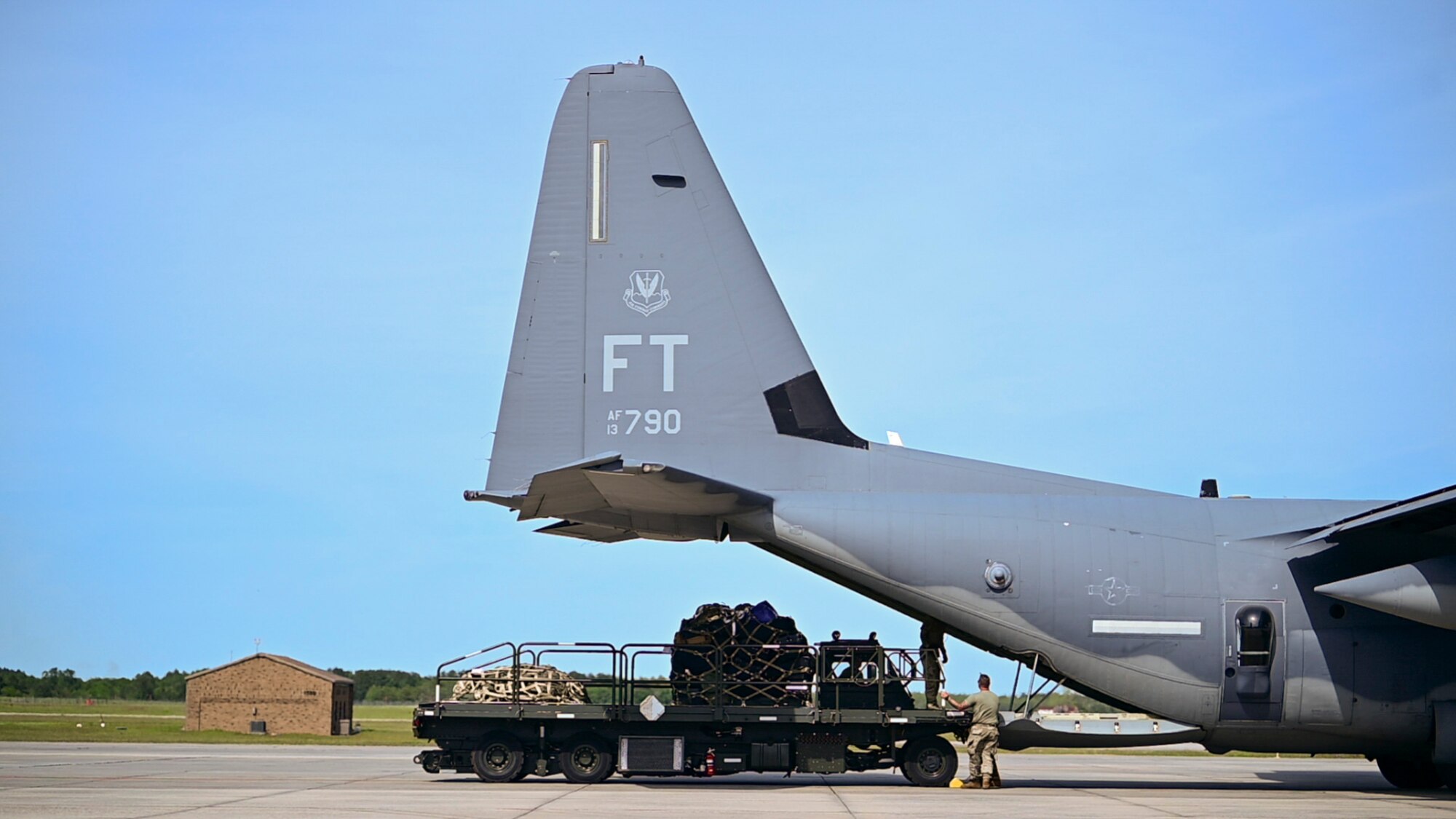 A U.S Air Force loadmaster assigned to the 71st Rescue Squadron prepares to load personnel and cargo onto an HC-130J Combat King II  during Exercise Ready Tiger 24-1 at Moody Air Force Base, Georgia, April 8, 2024. Loadmasters are responsible for supervising the loading and unloading of cargo, vehicles and people on a variety of aircraft. During Ready Tiger 24-1, exercise inspectors will assess the 23rd Wing's proficiency in employing decentralized command and control to fulfill air tasking orders across geographically dispersed areas amid communication challenges, integrating Agile Combat Employment principles such as integrated combat turns, forward aerial refueling points, multi-capable Airmen, and combat search and rescue capabilities. (U.S. Air Force photo by 2nd Lt. Benjamin Williams)