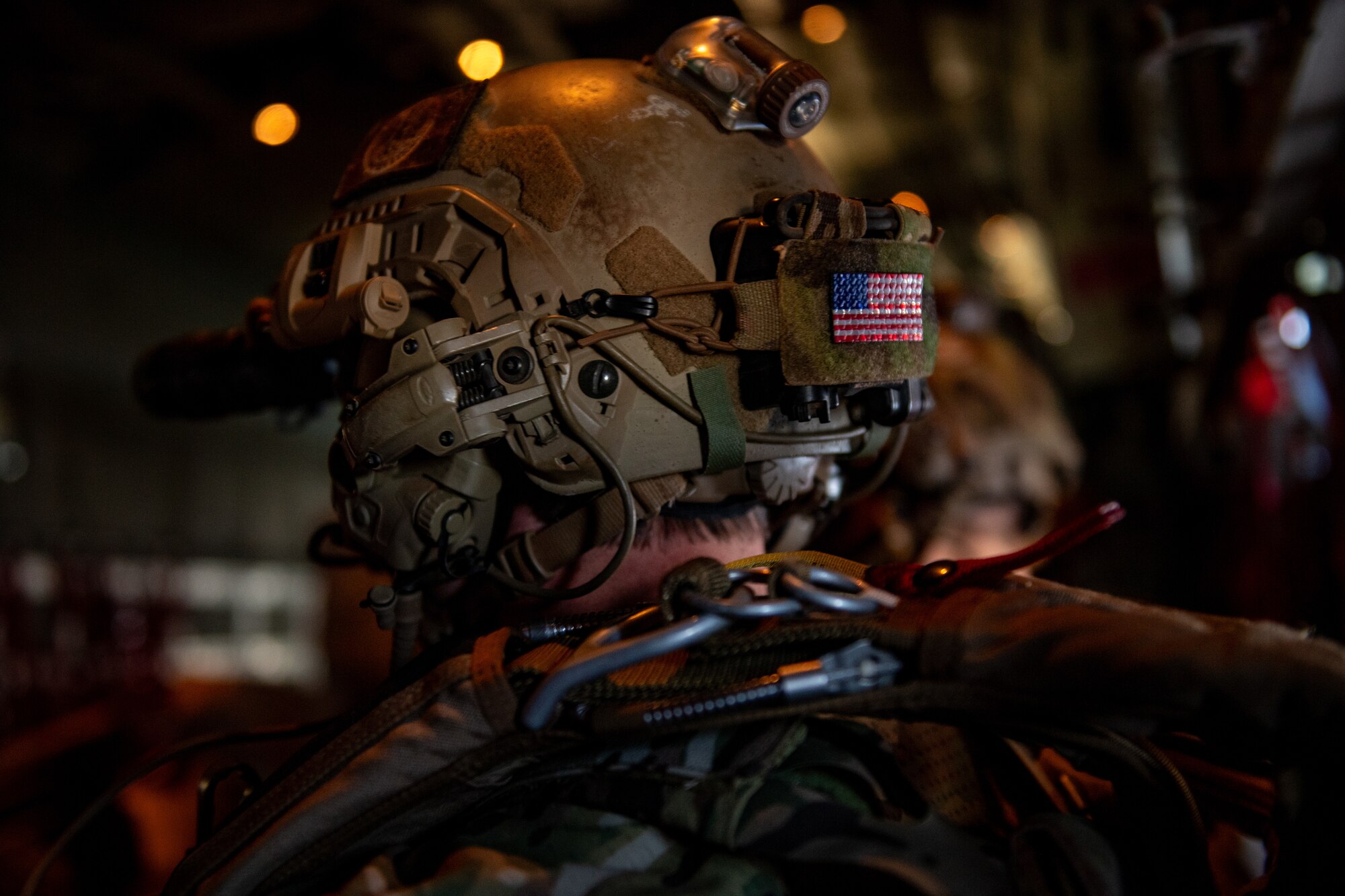 An American flag patch adorns the helmet of a 38th Rescue Squadron pararescueman during Exercise Ready Tiger 24-1 1 at Savannah Air National Guard Base, Georgia, April 11, 2024. The exercise simulated a downed pilot scenario which tested the combat search and rescue team’s ability to respond at a moment's notice from a forward operating site. During Ready Tiger 24-1, exercise inspectors will assess the 23rd Wing's proficiency in employing decentralized command and control to fulfill air tasking orders across geographically dispersed areas amid communication challenges, integrating Agile Combat Employment principles such as integrated combat turns, forward aerial refueling points, multi-capable Airmen, and combat search and rescue capabilities. (U.S. Air Force photo by Senior Airman Courtney Sebastianelli)