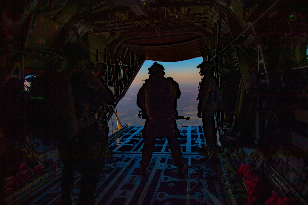 A U.S. Air Force Airman assigned to the 38th Rescue Squadron waits for clearance to do a military free fall jump during Exercise Ready Tiger 24-1, April 12, 2024. The exercise simulated a downed pilot scenario which tested the combat search and rescue team’s ability to respond at a moment's notice from a forward operating site. During Ready Tiger 24-1, exercise inspectors will assess the 23rd Wing's proficiency in employing decentralized command and control to fulfill air tasking orders across geographically dispersed areas amid communication challenges, integrating Agile Combat Employment principles such as integrated combat turns, forward aerial refueling points, multi-capable Airmen, and combat search and rescue capabilities. (U.S. Air Force photo by Senior Airman Courtney Sebastianelli)